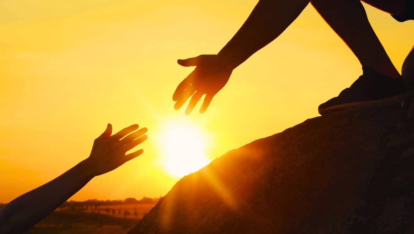 Hiker offering a hand up for Rookie Anglican Fund. Photo by Africa images, courtesy of Canva.